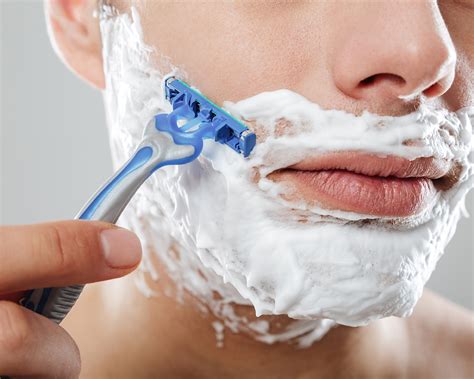 Detailní záběr na holení hlavy žiletkou