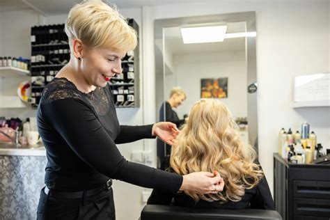 stylista pracujúci s klientkou v salóne